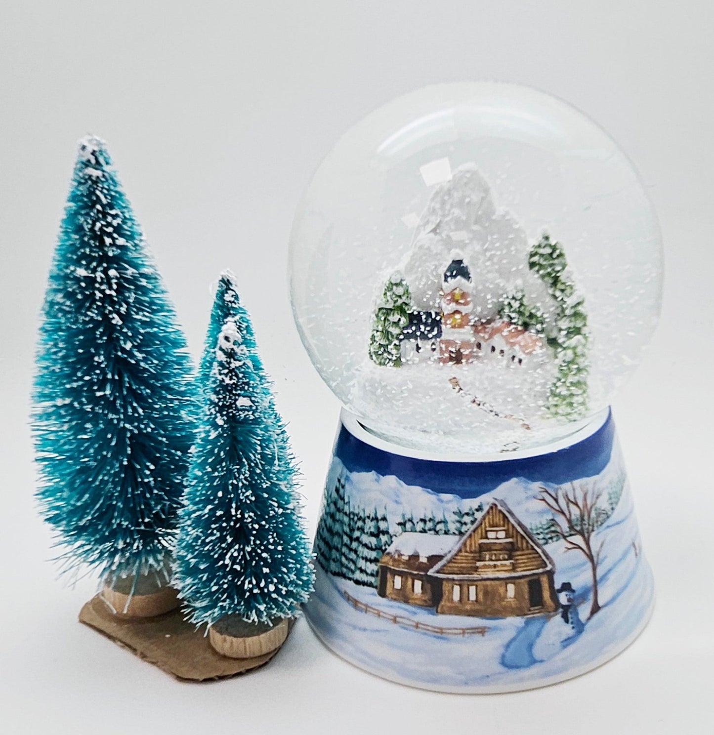 Nostalgische Schneekugel Bergdorf auf Sockel Winterlandschaft mittelblau 100 mm Durchmesser mit Spieluhr - Schneekugelhaus